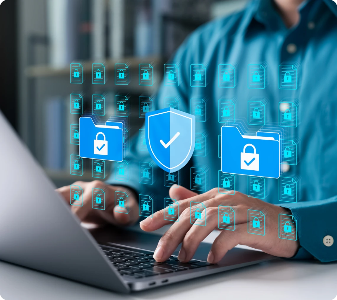 Person using laptop with security graphics